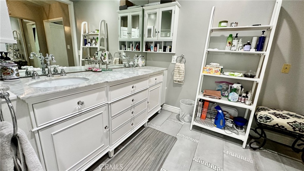 19559 Tulsa Street Porter Ranch, CA 91326 - Photo 27 of 55 a bathroom with a double vanity sink and a mirror