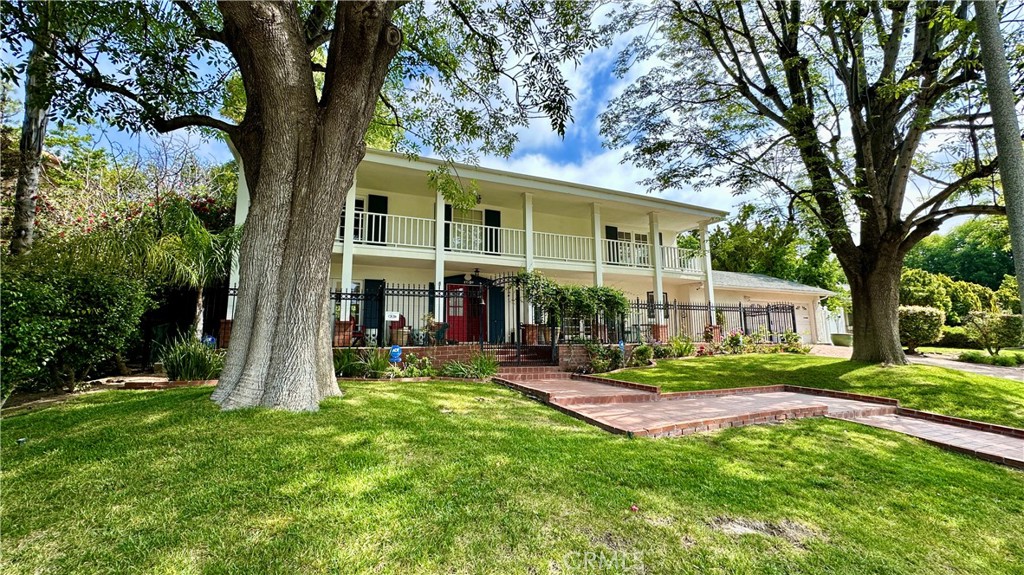19559 Tulsa Street Porter Ranch, CA 91326 - Photo 3 of 55 a view of a house with a yard and sitting area