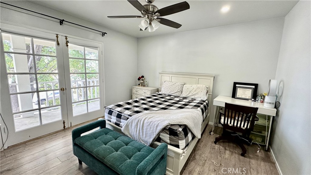 19559 Tulsa Street Porter Ranch, CA 91326 - Photo 31 of 55 a bedroom with a bed lamp and a large window