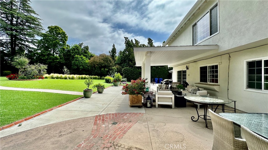 19559 Tulsa Street Porter Ranch, CA 91326 - Photo 39 of 55 a view of a patio with couches table and chairs with garden