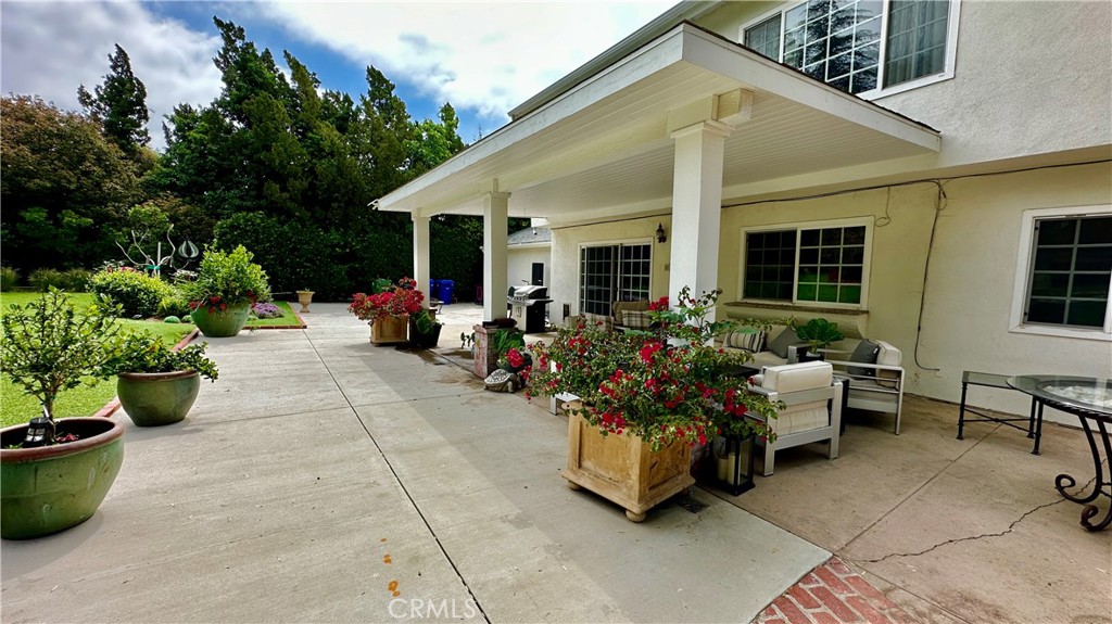 19559 Tulsa Street Porter Ranch, CA 91326 - Photo 40 of 55 a living room with furniture and flower plants