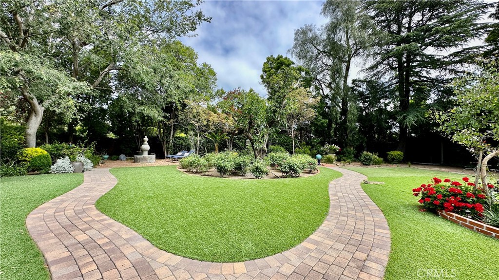 19559 Tulsa Street Porter Ranch, CA 91326 - Photo 42 of 55 a view of a garden with a fountain in the back yard