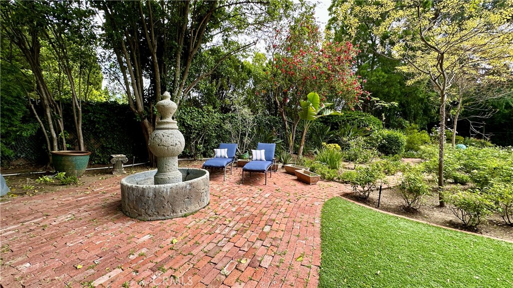 19559 Tulsa Street Porter Ranch, CA 91326 - Photo 45 of 55 a view of a patio with table and chairs potted plants and large tree