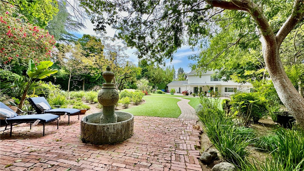 19559 Tulsa Street Porter Ranch, CA 91326 - Photo 46 of 55 a view of a garden with plants and large trees