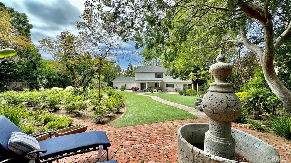 19559 Tulsa Street Porter Ranch, CA 91326 - Photo 47 of 55 a front view of a house with a yard and fountain
