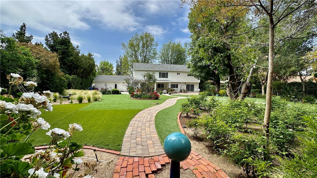 19559 Tulsa Street Porter Ranch, CA 91326 - Photo 50 of 55 a front view of a house with a yard table and chairs