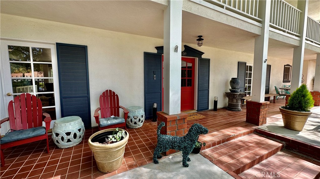 19559 Tulsa Street Porter Ranch, CA 91326 - Photo 5 of 55 a living room with chair and a potted plant