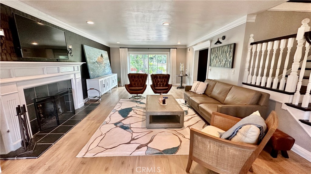 19559 Tulsa Street Porter Ranch, CA 91326 - Photo 9 of 55 a living room with furniture a flat screen tv and a fireplace