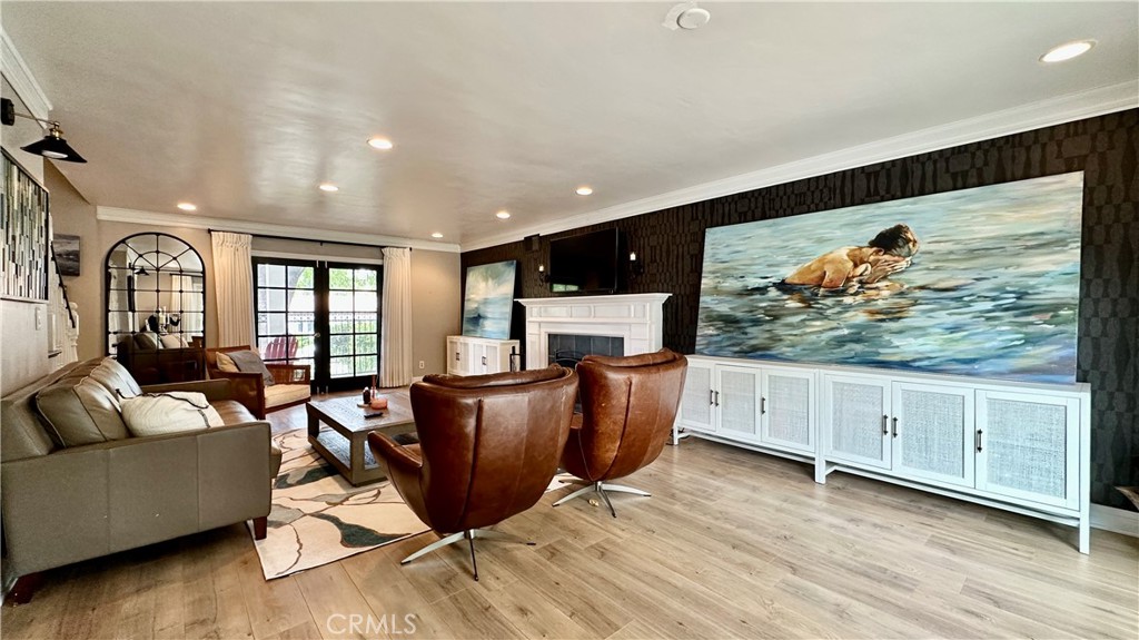 19559 Tulsa Street Porter Ranch, CA 91326 - Photo 10 of 55 a living room with furniture a flat screen tv and a wooden floor