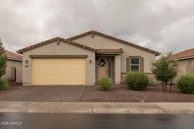 a front view of a house with a yard and garage