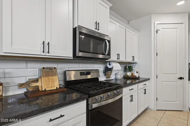 a kitchen with stainless steel appliances granite countertop a stove and a microwave