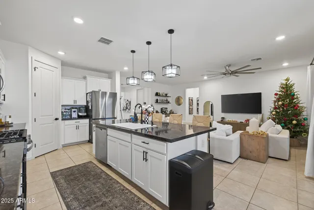 a kitchen with stainless steel appliances kitchen island granite countertop a sink and cabinets