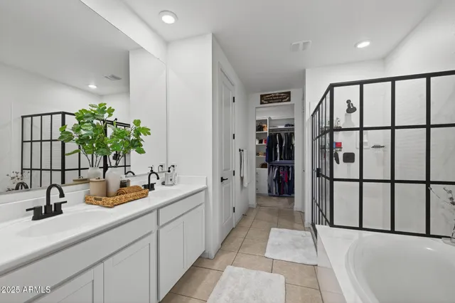 a bathroom with a double vanity sink and a large mirror