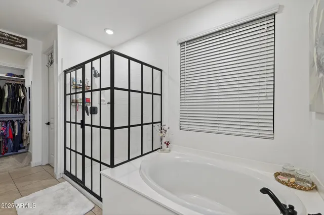 a bathroom with a bathtub and a window