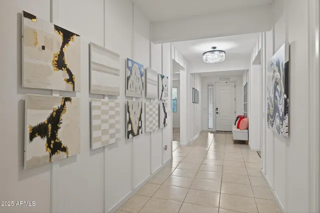 a view of a yard in front of a house with large windows