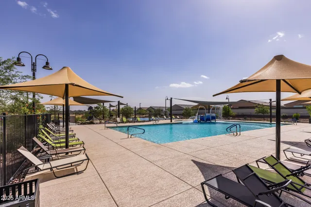 a view of a patio with a table and chairs under an umbrella