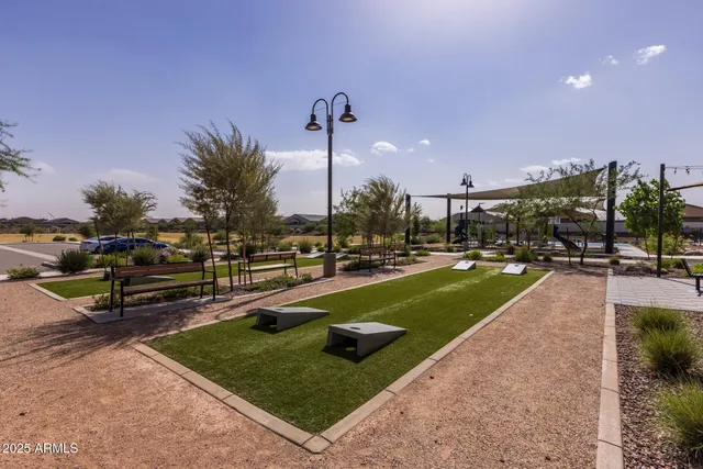 a living room with furniture a fireplace and large windows