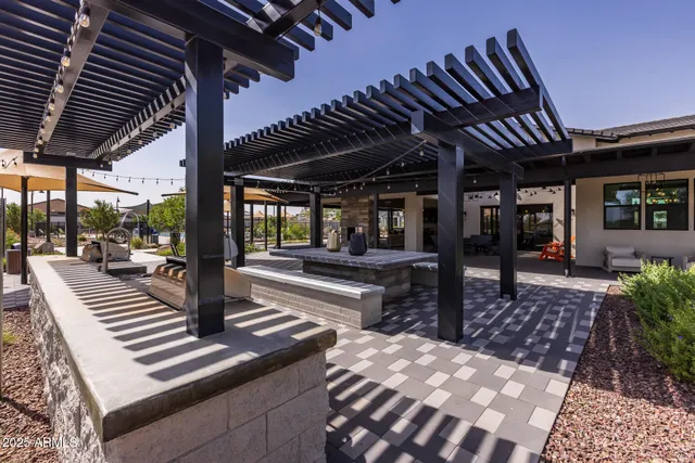 a view of swimming pool with seating area and barbeque oven