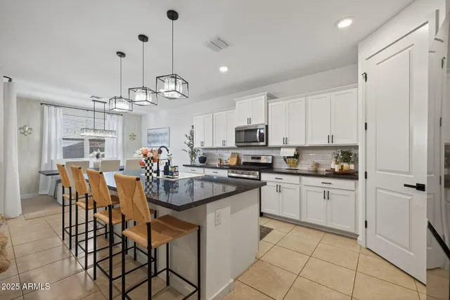 a kitchen that has a lot of cabinets in it and appliances