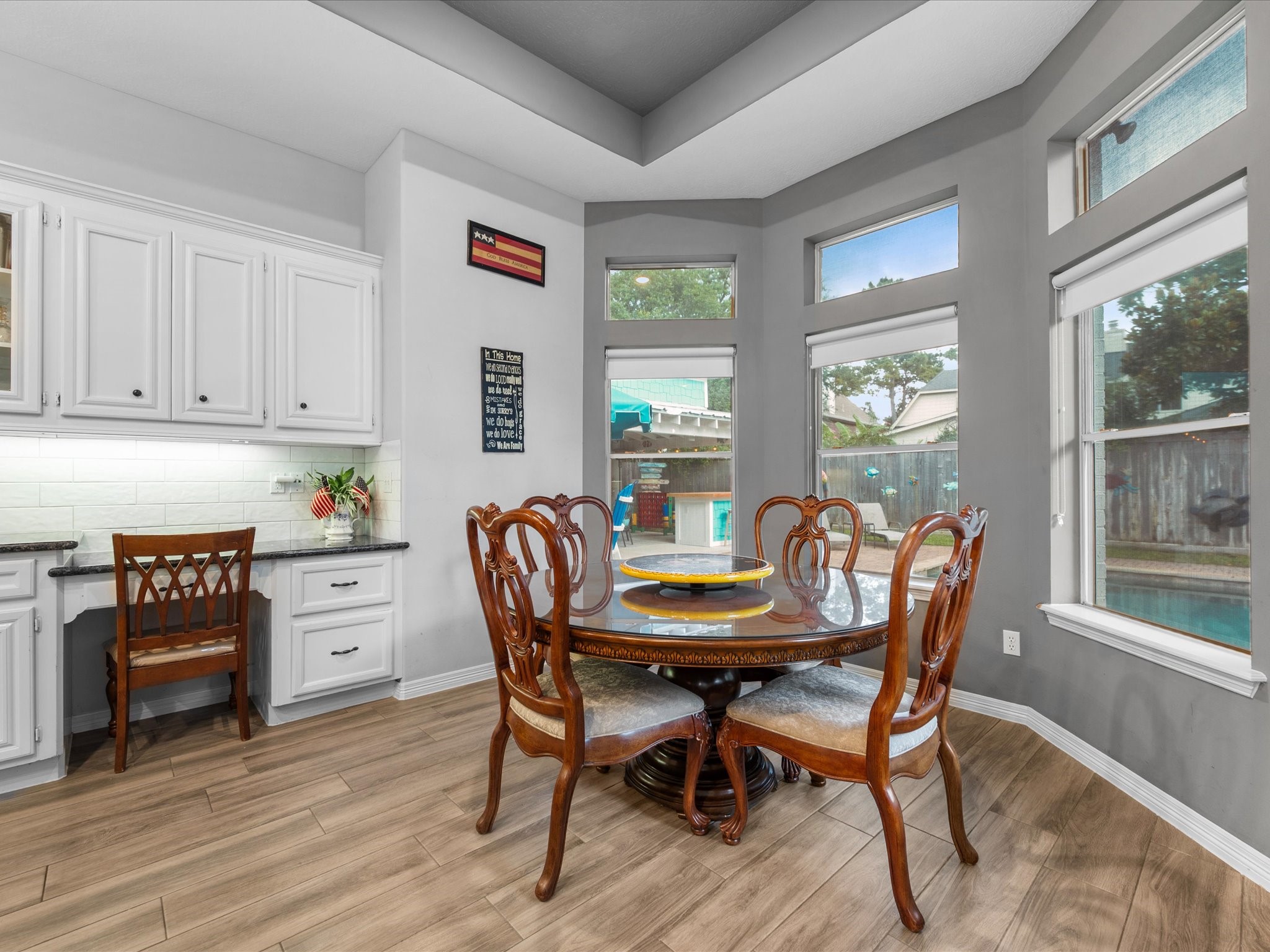 5910 Center Ct Drive Spring, TX 77379 - Photo 19 of 50 A bright breakfast nook with a built-in desk area overlooks the backyard through large windows, creating a peaceful and functional everyday space.