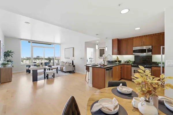 a living room with stainless steel appliances kitchen island granite countertop furniture and a kitchen view