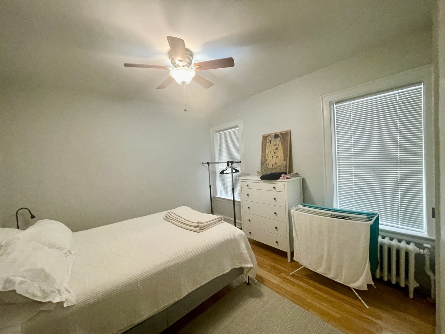 1112 Grove Street, Unit 1B Evanston, IL 60201 - Photo 10 of 14 a bedroom with a bed and a chandelier