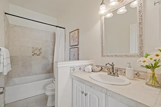 a spacious bathroom with a double vanity sink and mirror