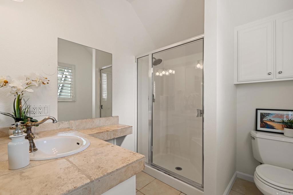 14403 Gaslight Court Poway, CA 92064 - Photo 39 of 58 a bathroom with a granite countertop sink a mirror and a shower