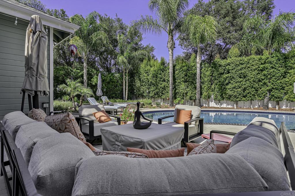 14403 Gaslight Court Poway, CA 92064 - Photo 51 of 58 a view of a backyard with couches table and chairs and potted plants