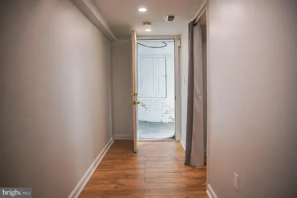 a view of a hallway with wooden floor