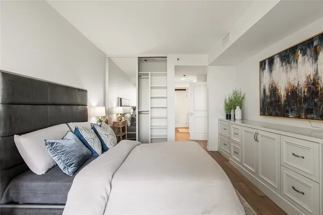 a bedroom with a large bed and a dresser