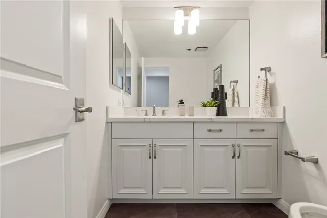 a bathroom with a sink vanity and a mirror