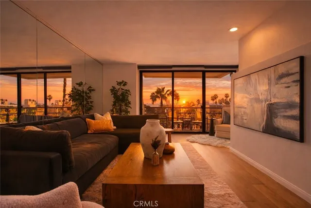 a living room with furniture large window and a flat screen tv