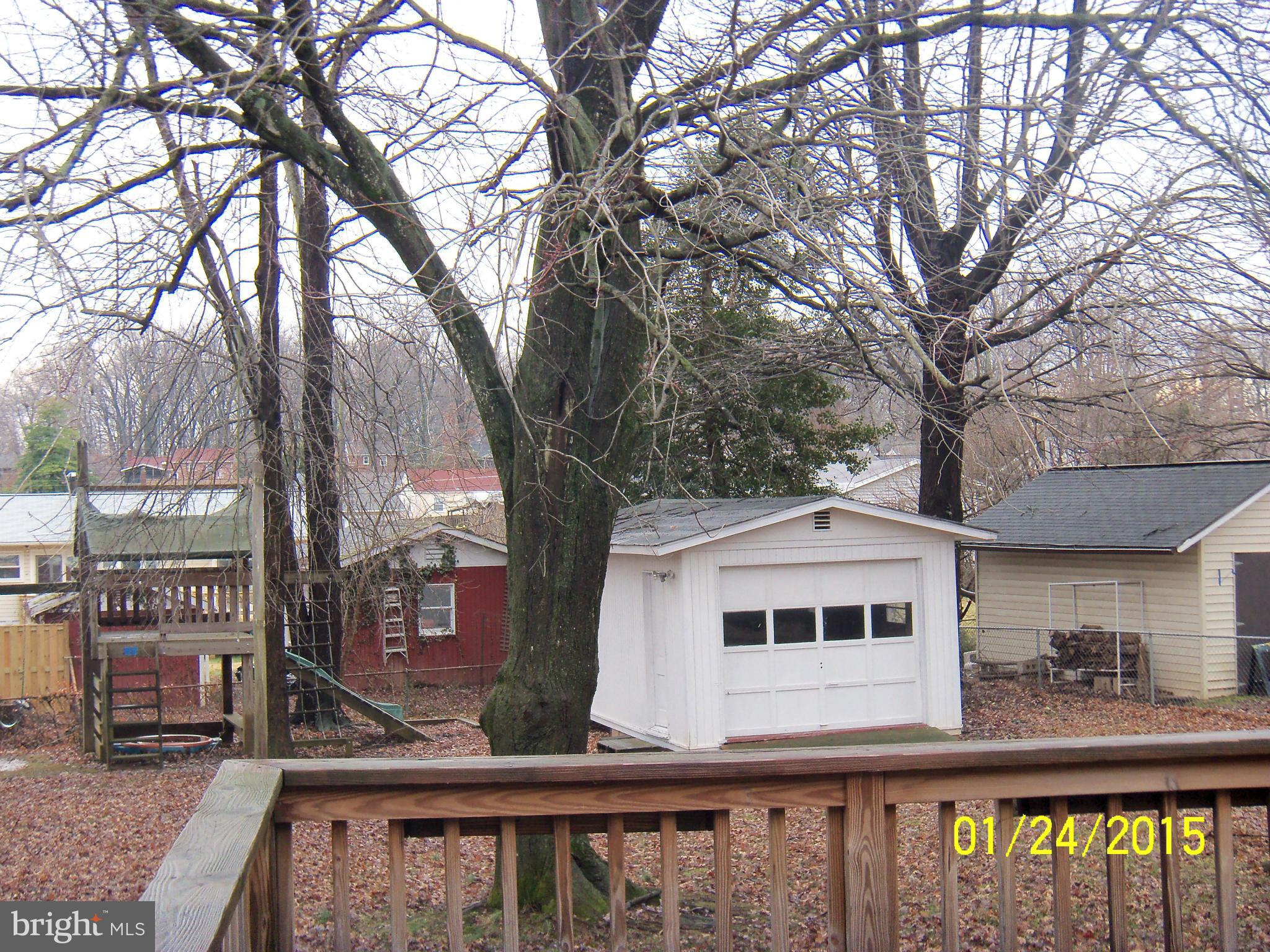 10213 Rodgers Road Fairfax, VA 22030 - Photo 22 of 26 a front view of a house with large trees