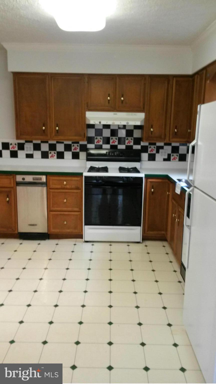 10213 Rodgers Road Fairfax, VA 22030 - Photo 5 of 26 a kitchen with stainless steel appliances a stove a sink and a refrigerator