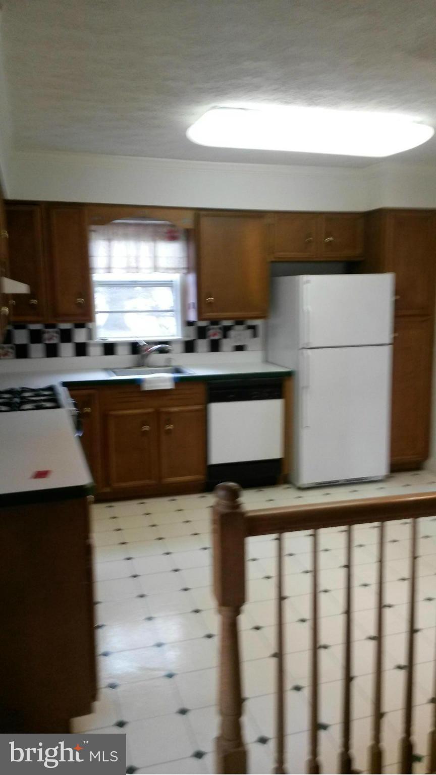 10213 Rodgers Road Fairfax, VA 22030 - Photo 6 of 26 a kitchen with stainless steel appliances a stove a sink and a microwave