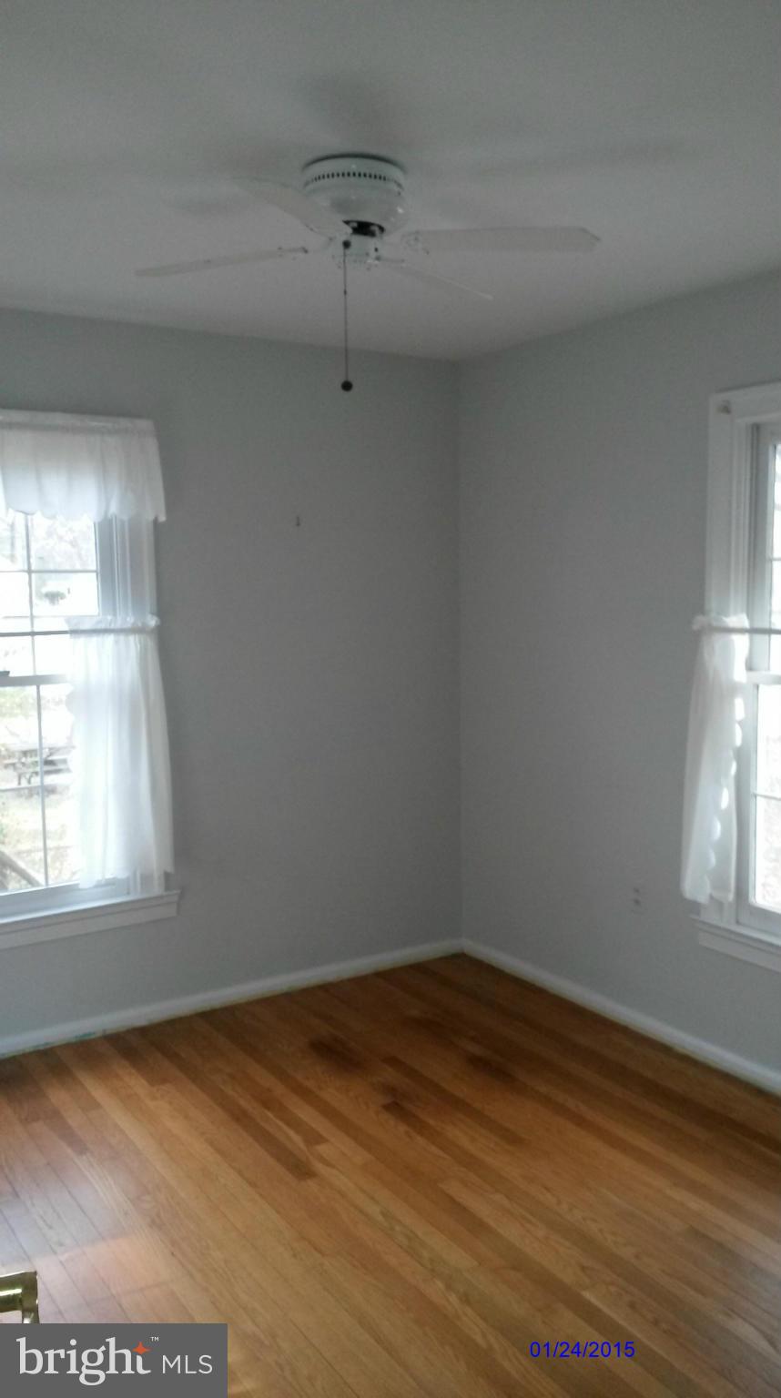 10213 Rodgers Road Fairfax, VA 22030 - Photo 8 of 26 a view of empty room with wooden floor and fan