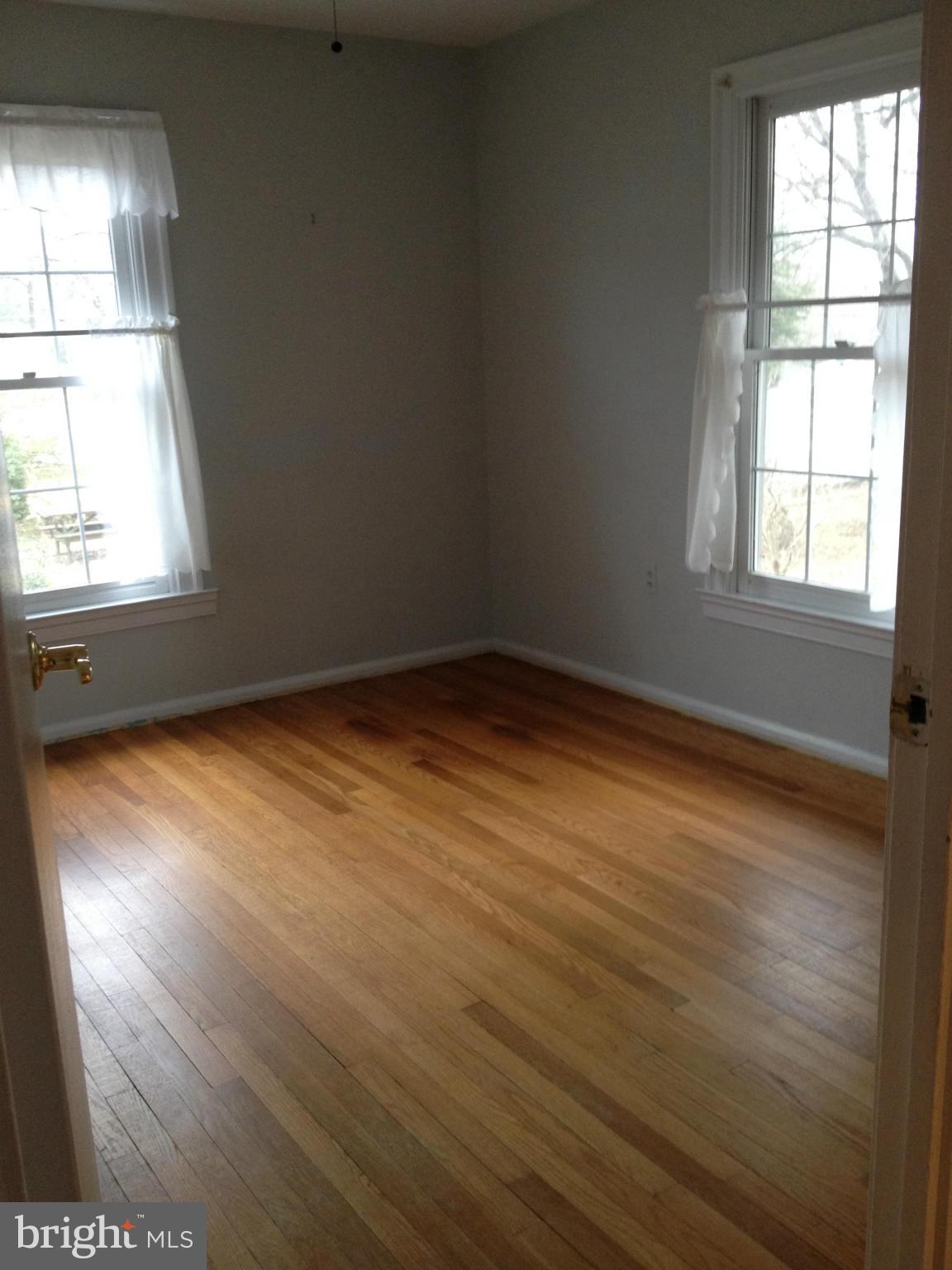10213 Rodgers Road Fairfax, VA 22030 - Photo 10 of 26 an empty room with wooden floor and windows
