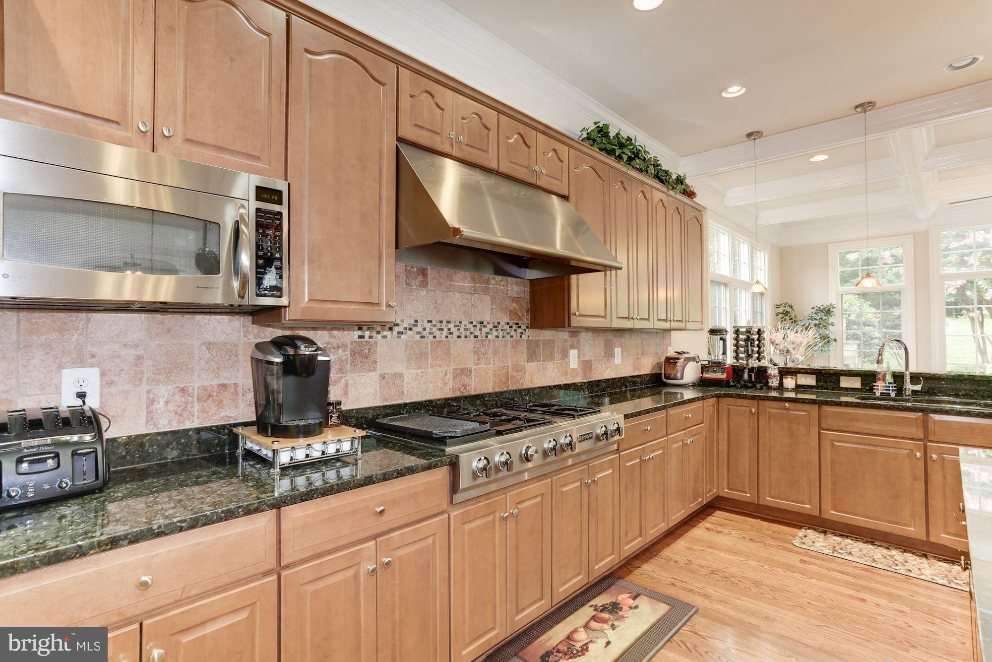 9204 Jones Mill Road Chevy Chase, MD 20815 - Photo 13 of 50 a kitchen with granite countertop a sink a stove and cabinets