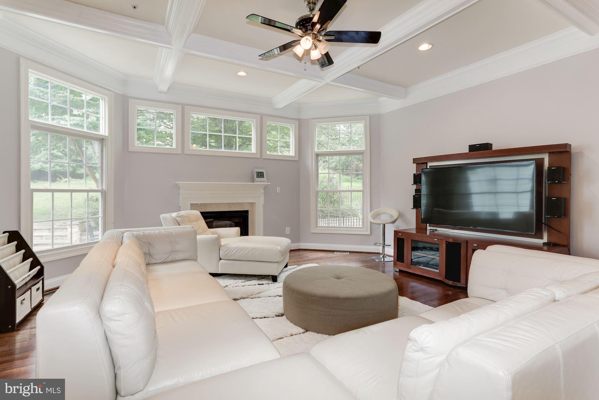 9204 Jones Mill Road Chevy Chase, MD 20815 - Photo 18 of 50 a living room with furniture a flat screen tv and a large window