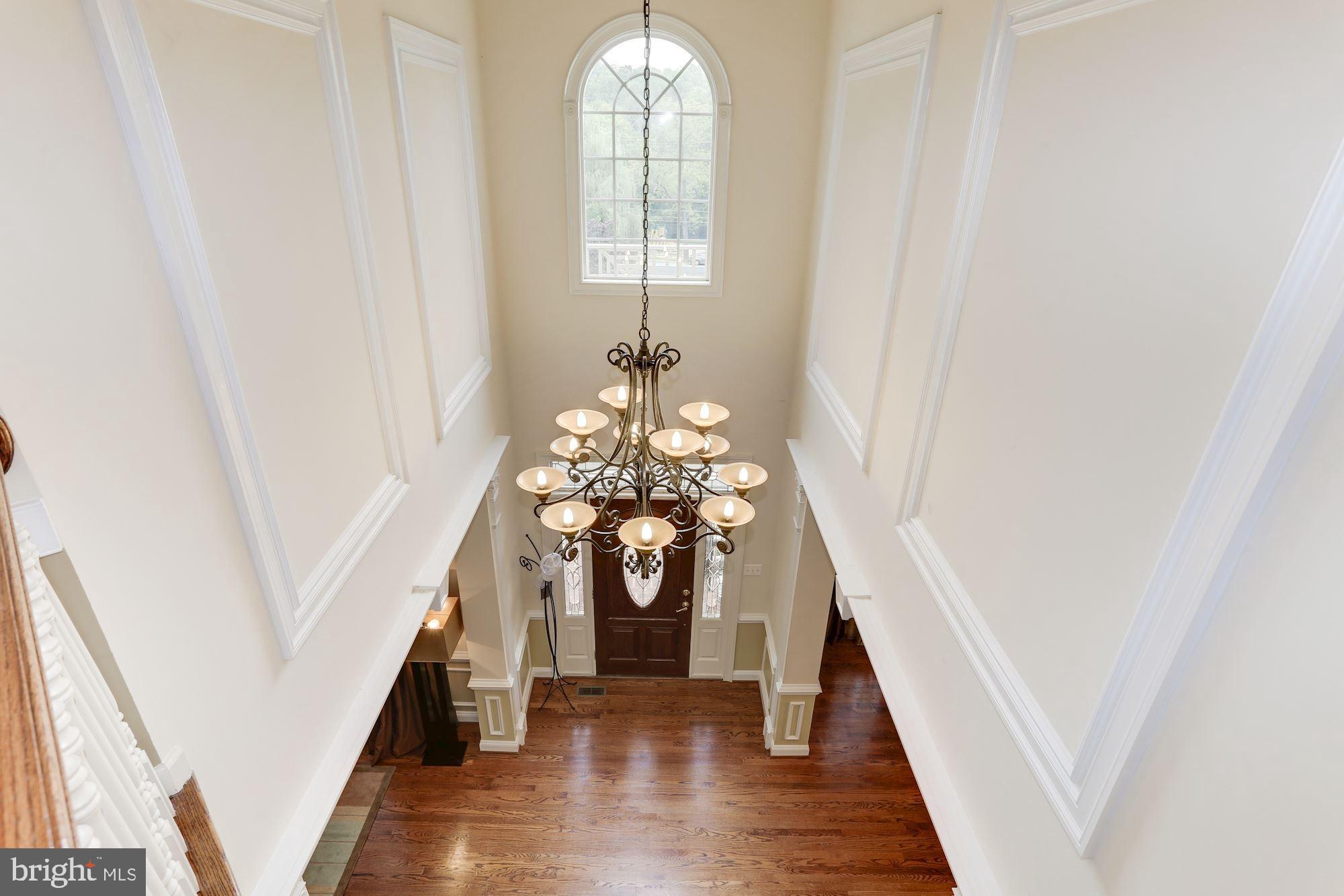 9204 Jones Mill Road Chevy Chase, MD 20815 - Photo 4 of 50 a view of a livingroom with wooden floor and stairs