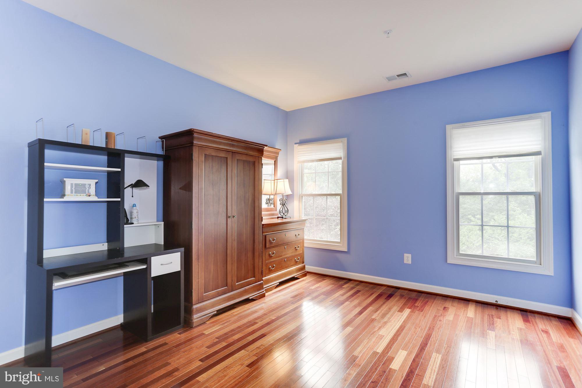 9204 Jones Mill Road Chevy Chase, MD 20815 - Photo 31 of 50 an empty room with wooden floor kitchen view and windows