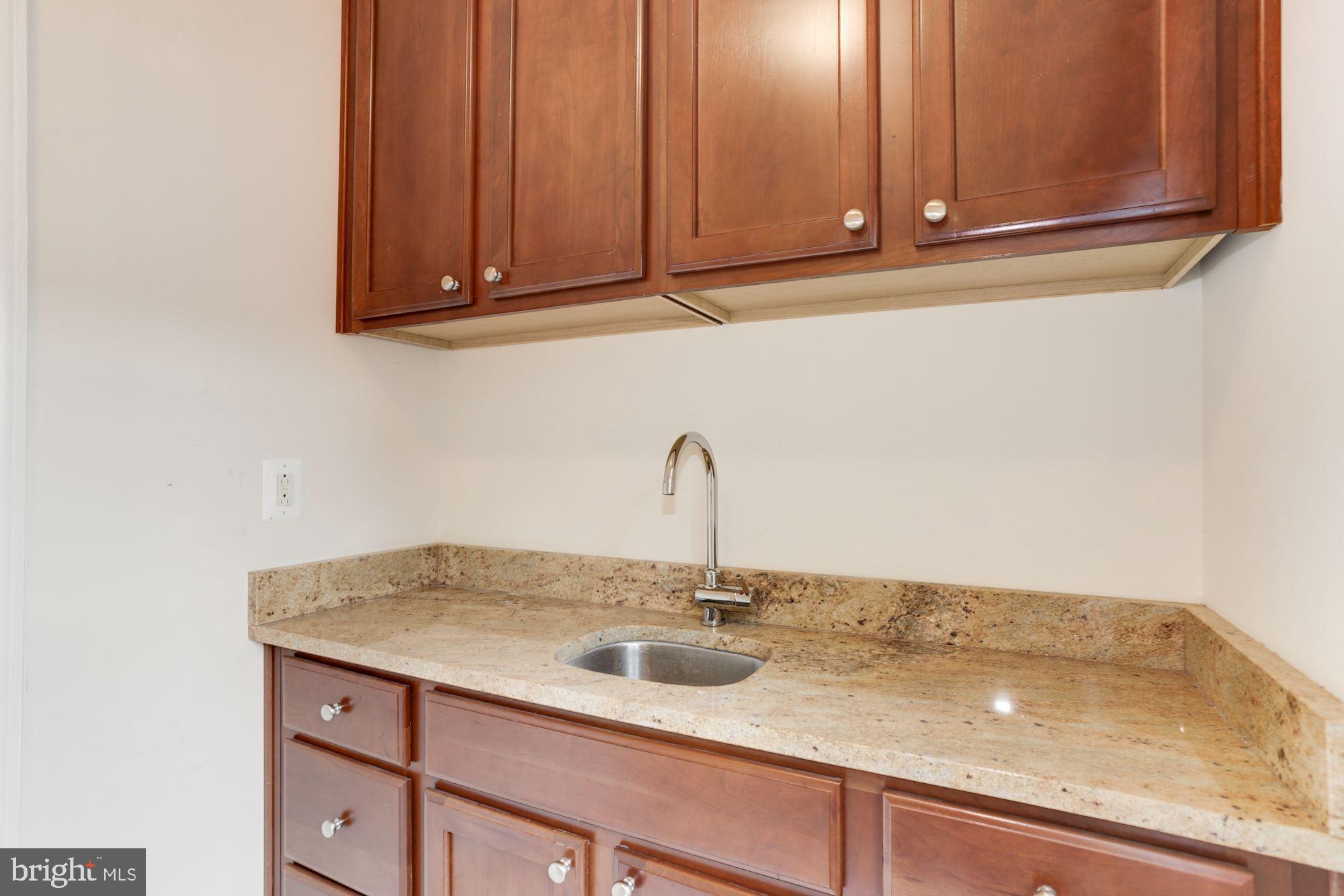 9204 Jones Mill Road Chevy Chase, MD 20815 - Photo 32 of 50 a bathroom with a sink and cabinets