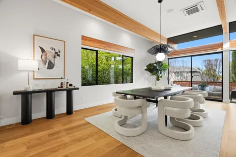 a living room with furniture a window and plants