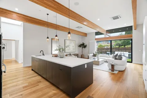 a view of living room with furniture and wooden floor