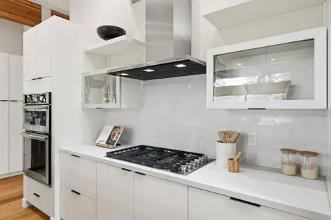 a kitchen with a stove and a refrigerator