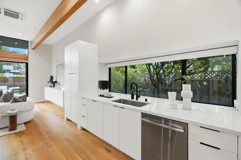 a kitchen with a sink and large window