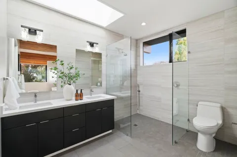 a bathroom with a toilet sink and mirror
