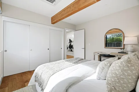 a bedroom with double bed and a window