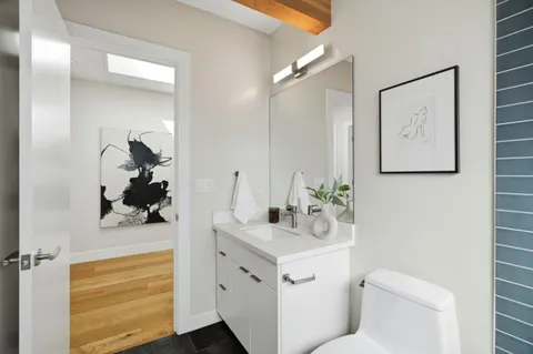 a bathroom with a sink toilet and mirror